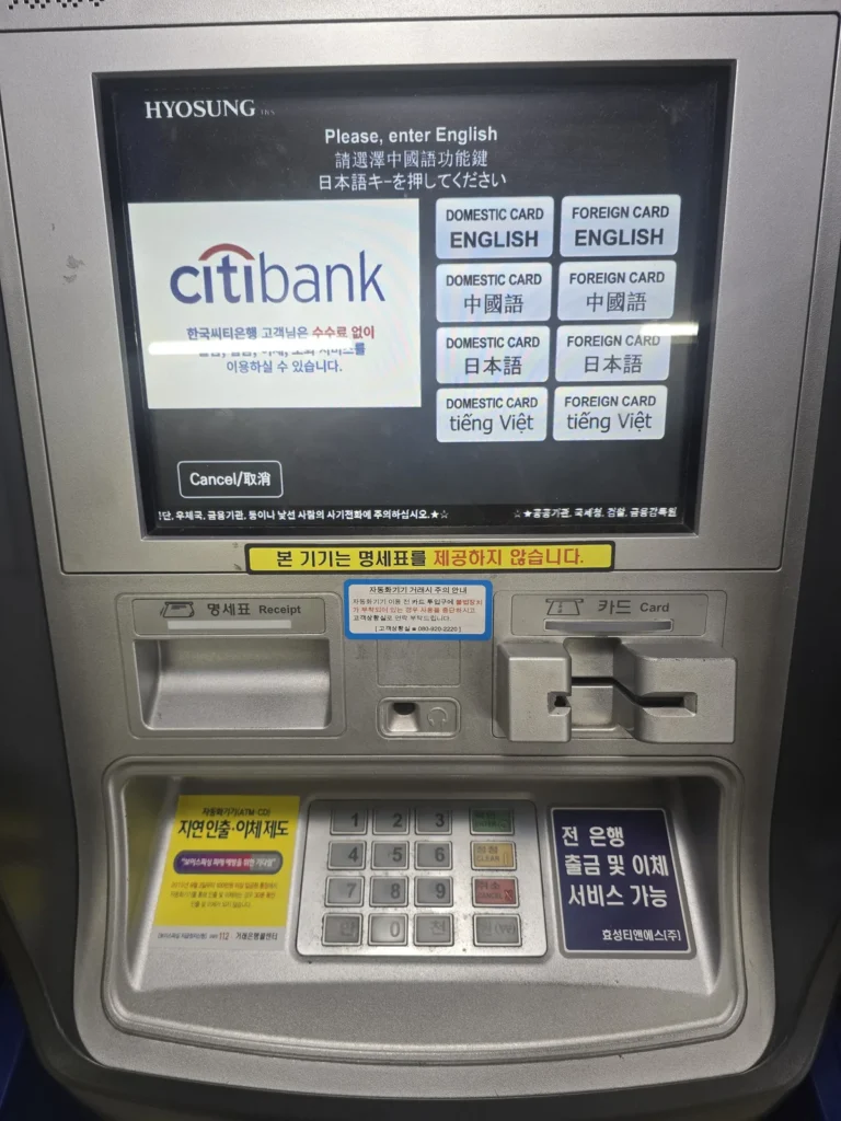 Hyosung ATM language screen with separate English options for domestic and foreign cards.