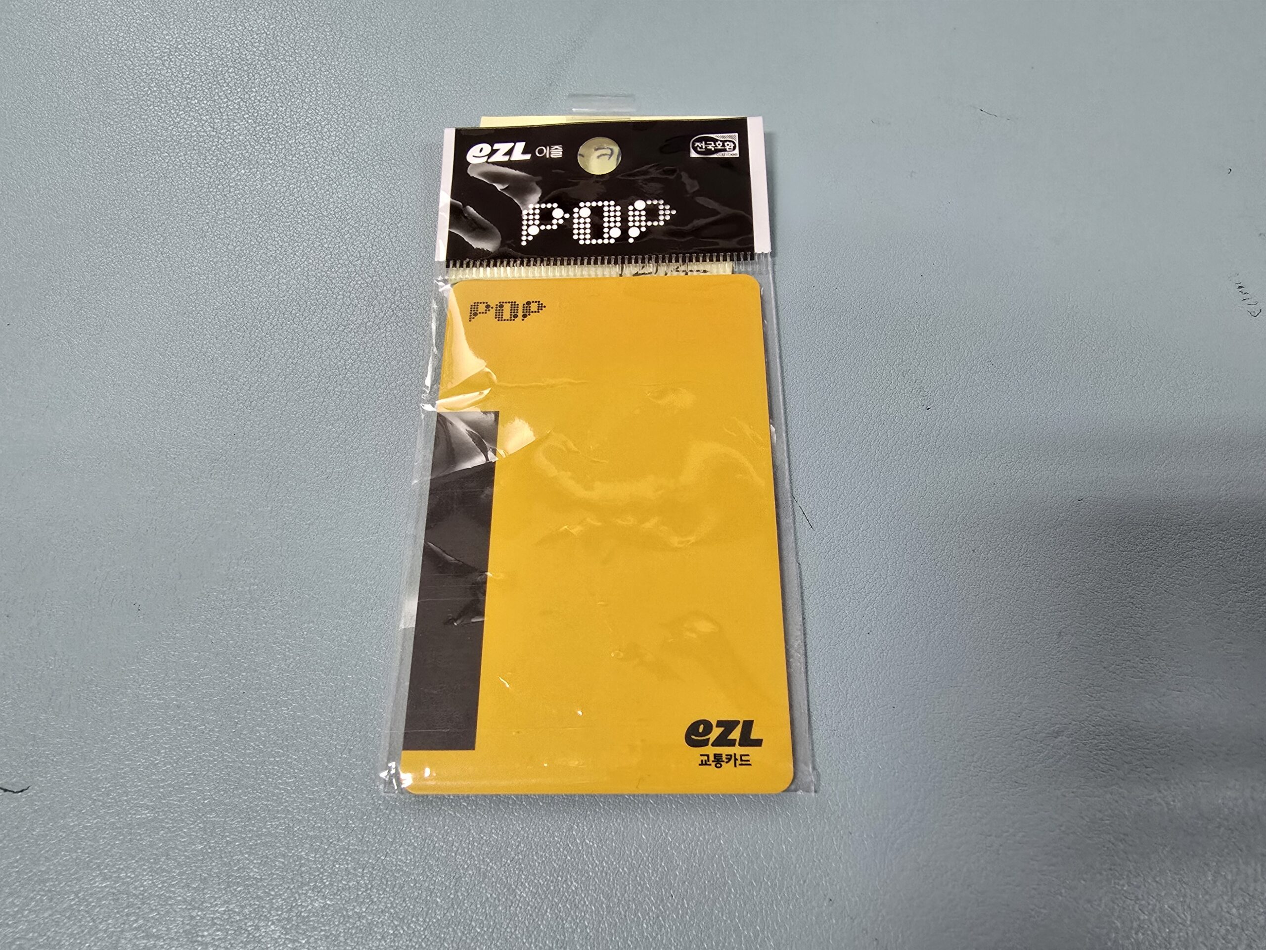 Yellow POP EZL transit card in its packaging.