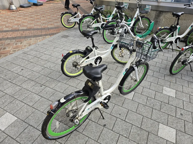 White Ttareungi public bicycles with green wheel rims and front baskets at a Seoul rental station
